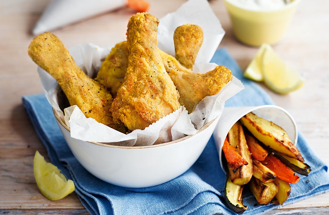 Chicken drumsticks with vegetable chips and garlic dip