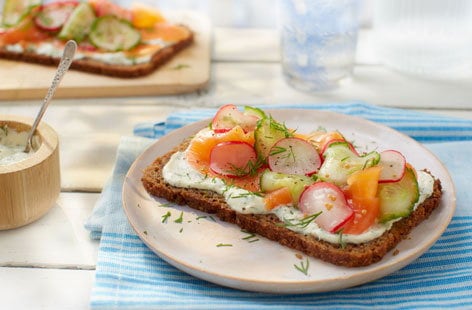 Image of "Smoked salmon and rye bread with pickled radishes and cucumber"