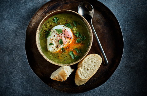 Image of "Pea and ham soup with poached eggs"