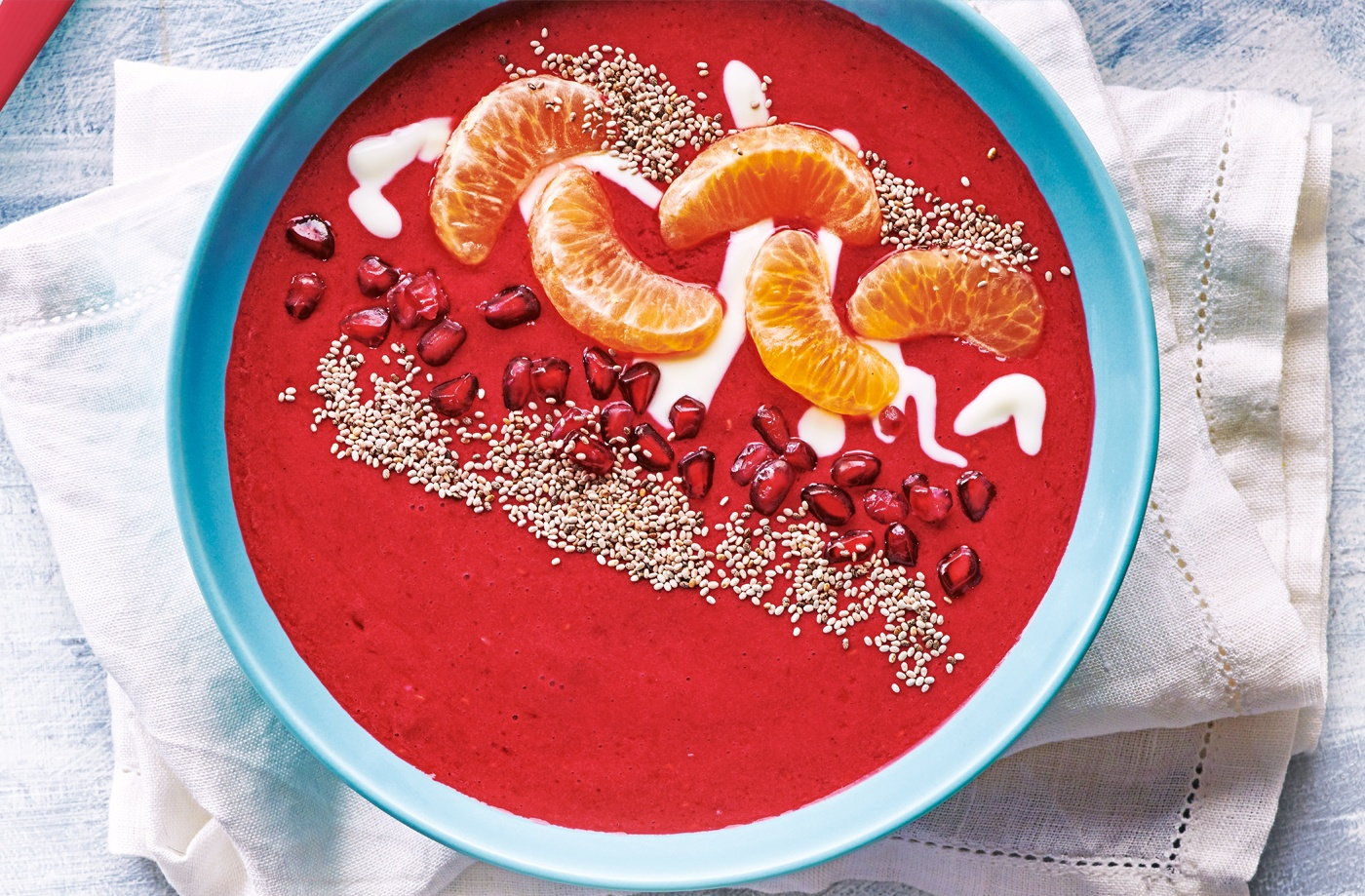 Raspberry smoothie bowl with pomegranate and clementine