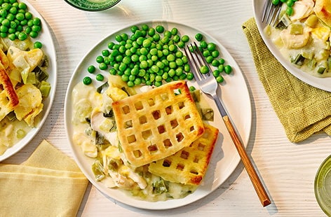 Image of "Creamy leek smoked fish with potato waffle topping"