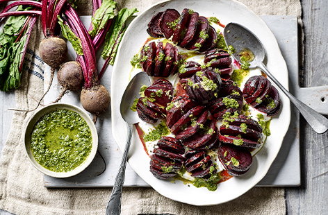 Image of "Hasselback beetroot with herby green dressing"