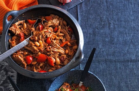 Image of "Smoky pulled pork stew with beans, peppers and orange gremolata"