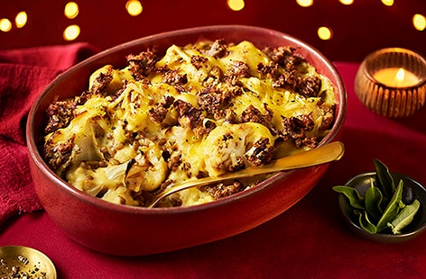 Image of "Creamy cauliflower and lentil gratin with sage and onion stuffing topping"