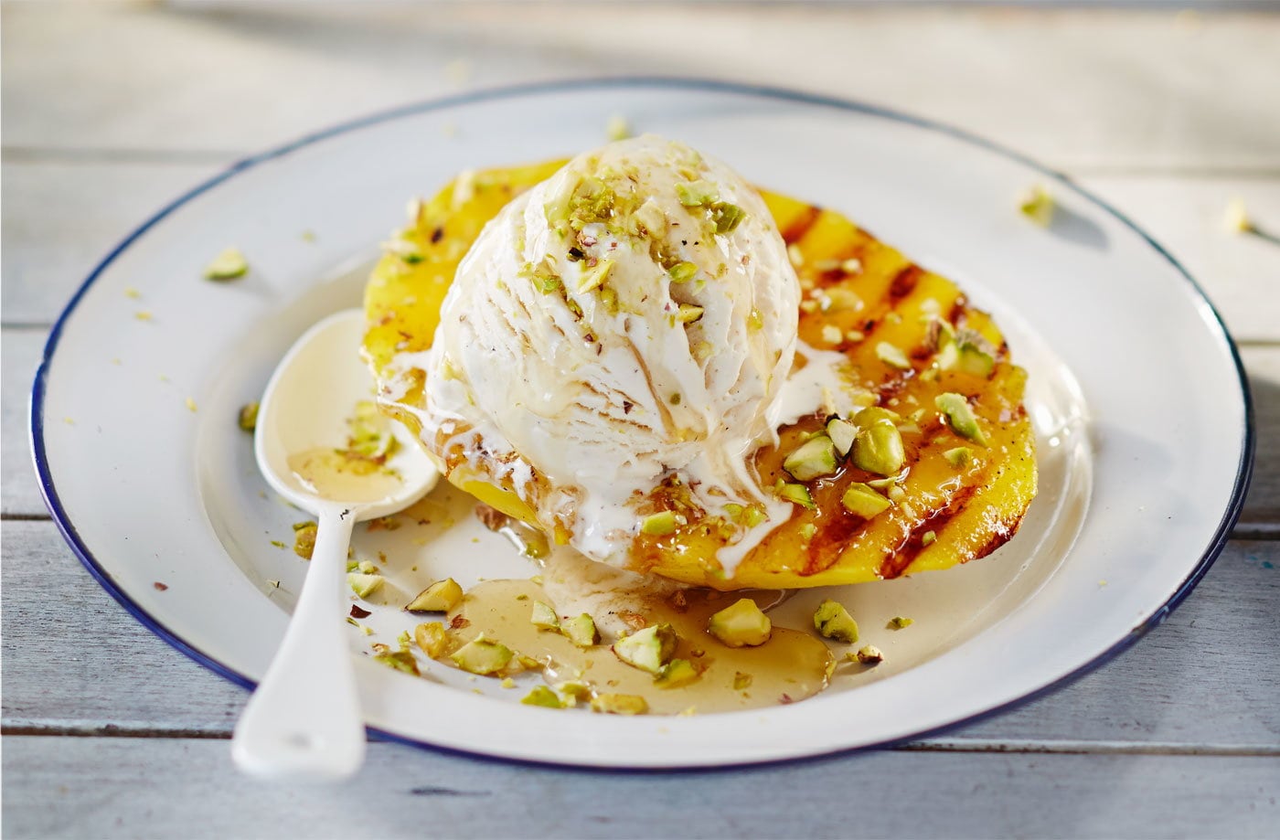 Barbecued mango with pistachio nuts and honey