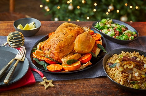 Image of "Citrus and herb roast chicken with crispy onion pilaf and charred sprouts"