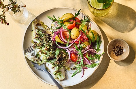 Pesto-crusted fish with potato, tomato and rocket salad