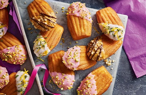 Image of "Rosé and pistachio dipped madeleines"