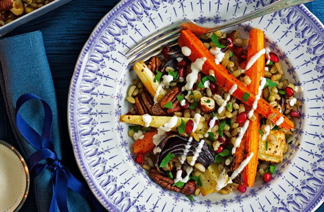Image of "Root and nut traybake with pomegranate and yogurt dressing"