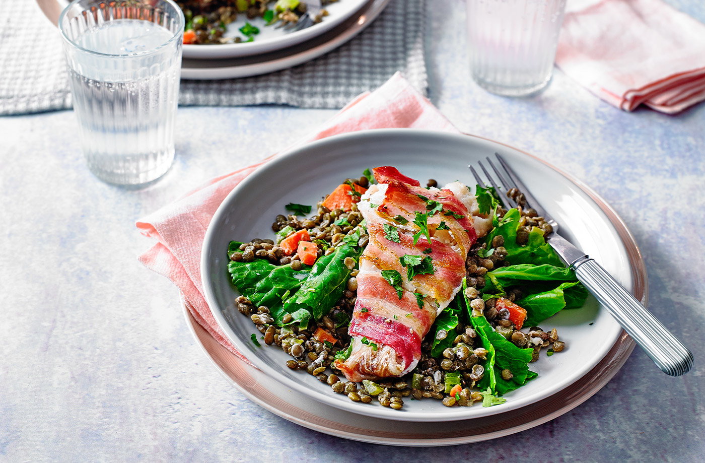 Bacon-wrapped fish with creamy lentils