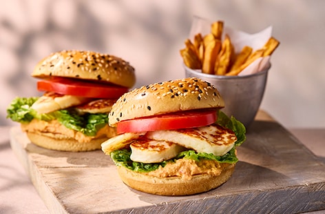 Image of "Halloumi burgers with red pepper houmous and sweet potato chips"