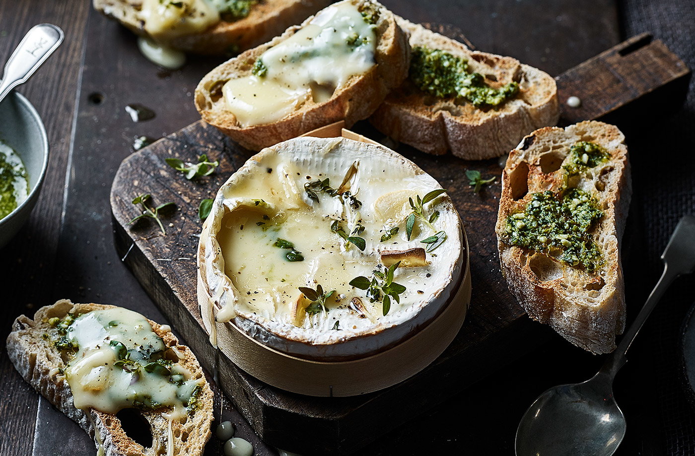 Baked smoked garlic cheese with pesto toasts