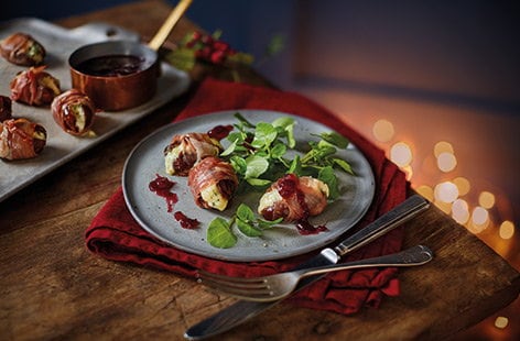Image of "Prosciutto wrapped dates with port and cranberry sauce"