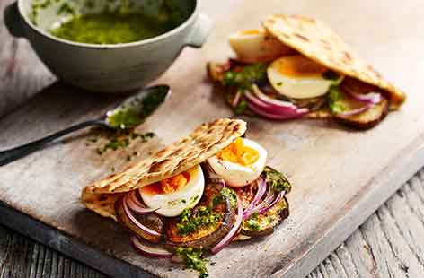 Image of "Aubergine, zhoug and egg flatbreads"