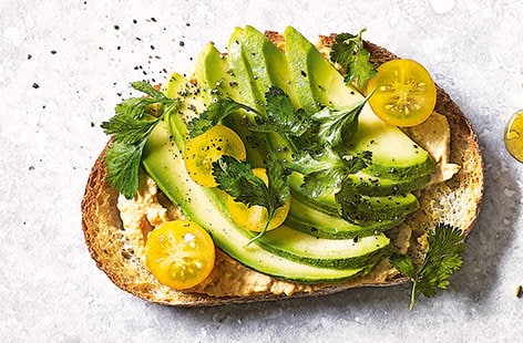 Image of "Houmous, avocado and yellow tomatoes toast topper"