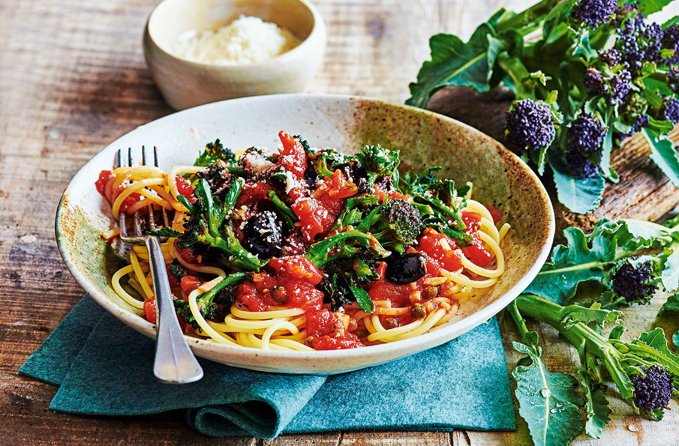Spaghetti with purple sprouting broccoli and tomato and olive sauce