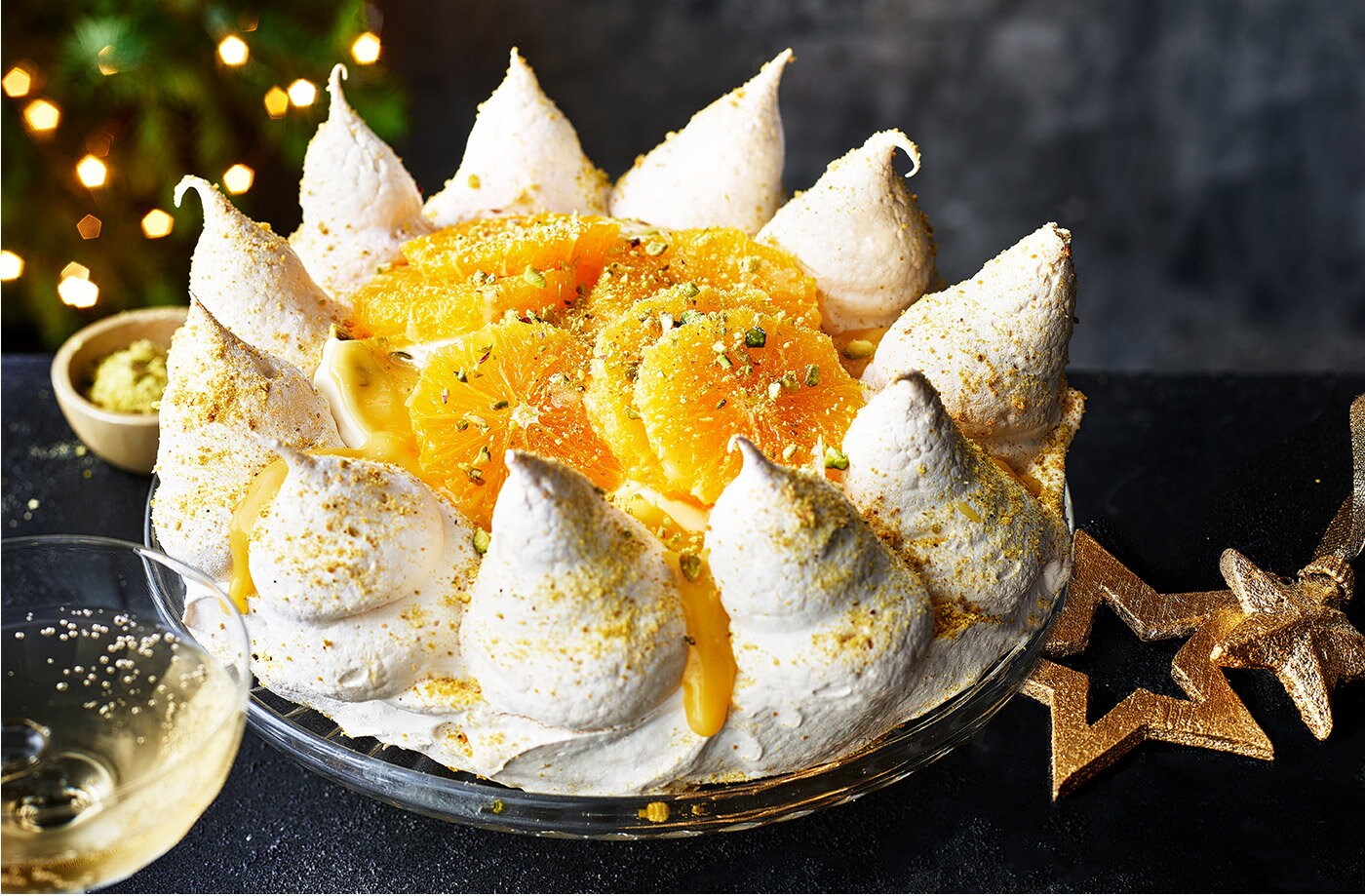 Orange, cardamom and pistachio pavlova crown