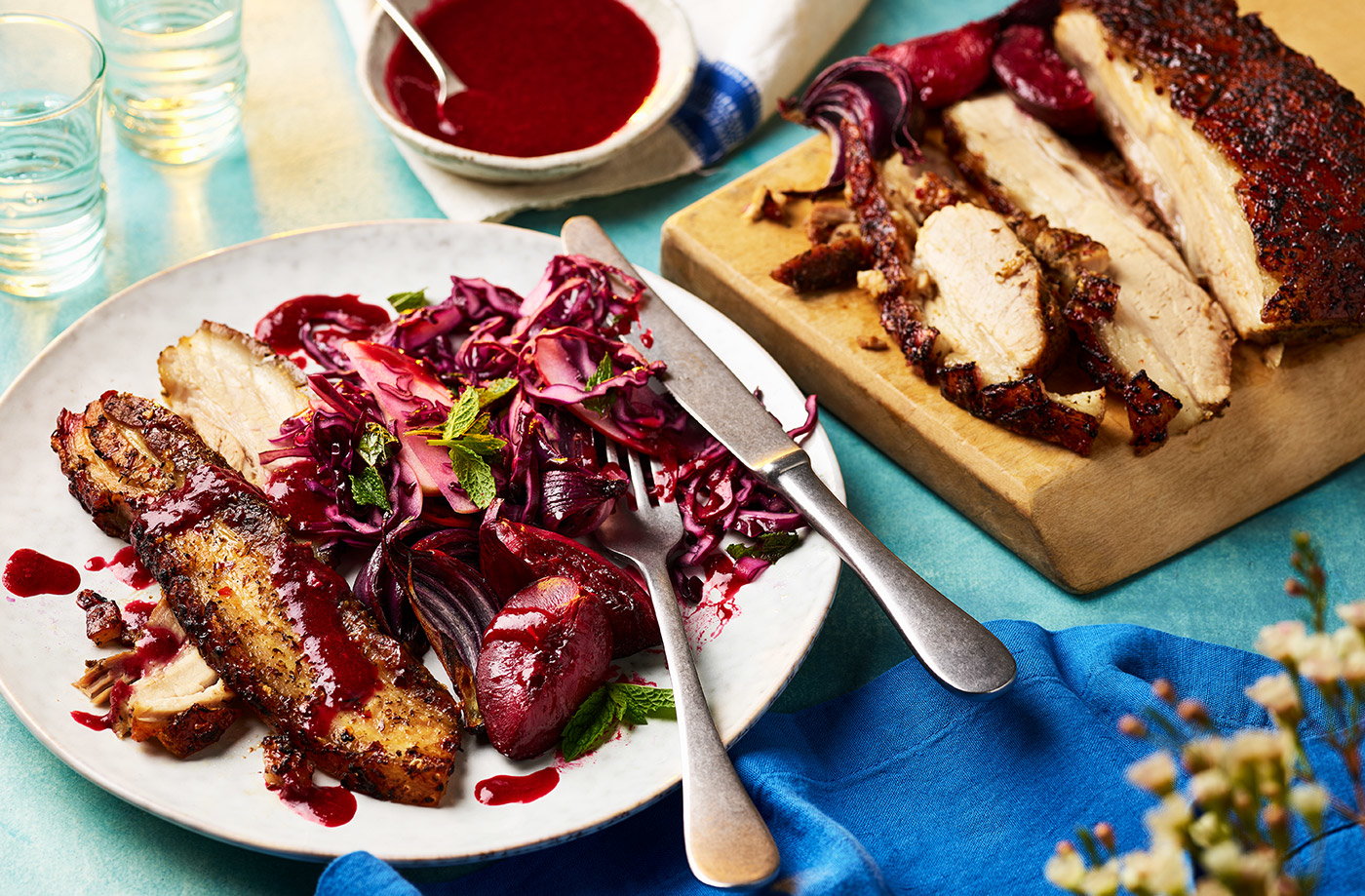 Slow-roast pork belly with sticky red onions and plum sauce