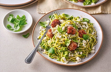Image of "Sausage meatballs with pea pesto and spaghetti"