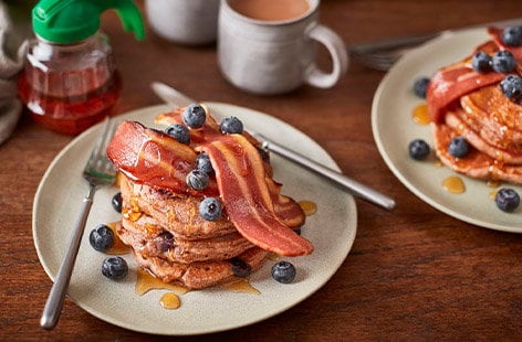 Image of "Vegan blueberry pancakes with crispy meat-free bacon"
