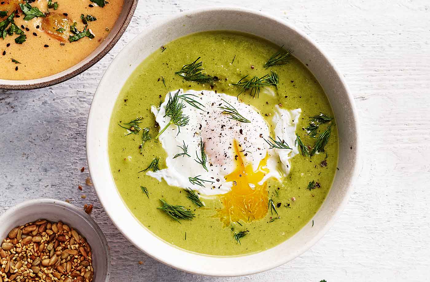 Pea and lettuce soup with poached eggs