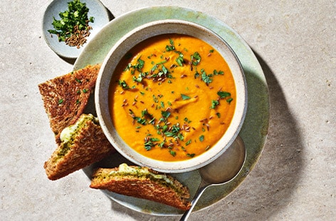 Image of "Spiced carrot and lentil soup with cheesy pesto toasties"
