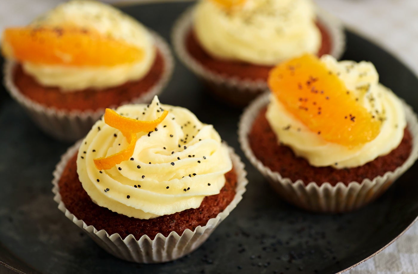 Orange and poppy seed cupcakes with cream cheese frosting