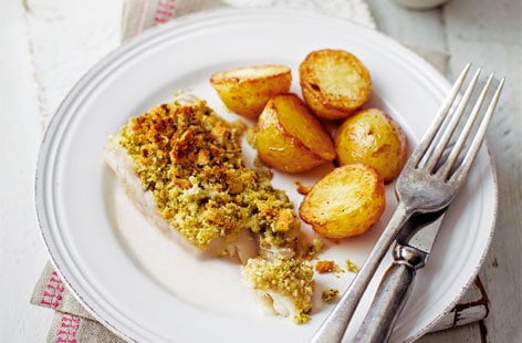 Image of "Lemon and pesto-crusted fish with potato wedges"