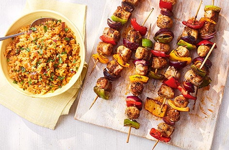 Image of "Smoky sausage skewers with tomato rice"