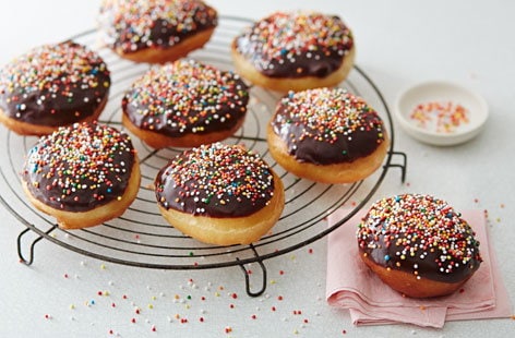 Image of "Chocolate dipped doughnuts with sprinkles"