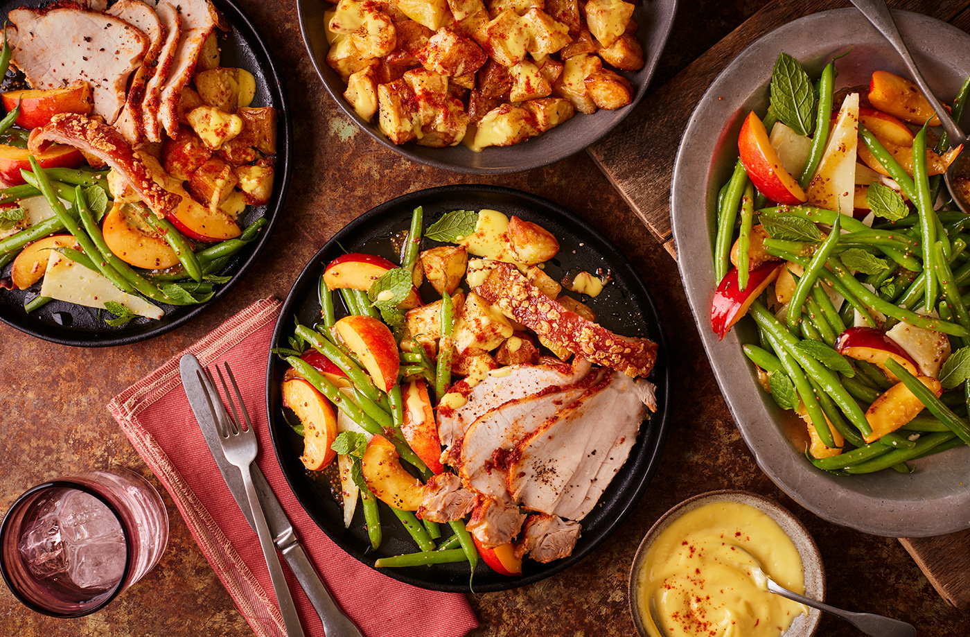 Paprika and garlic rubbed roast pork with roast potatoes, nectarine salad and saffron aioli