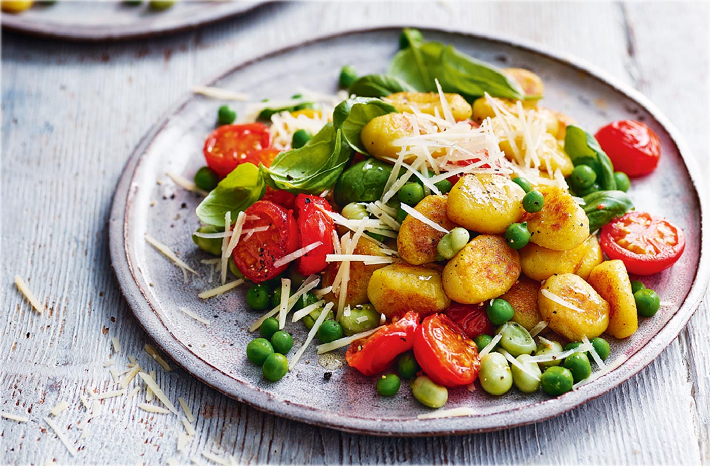 Crispy gnocchi with peas, broad beans and tomatoes