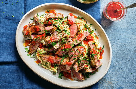 Image of "Grilled lamb with houmous and harissa"