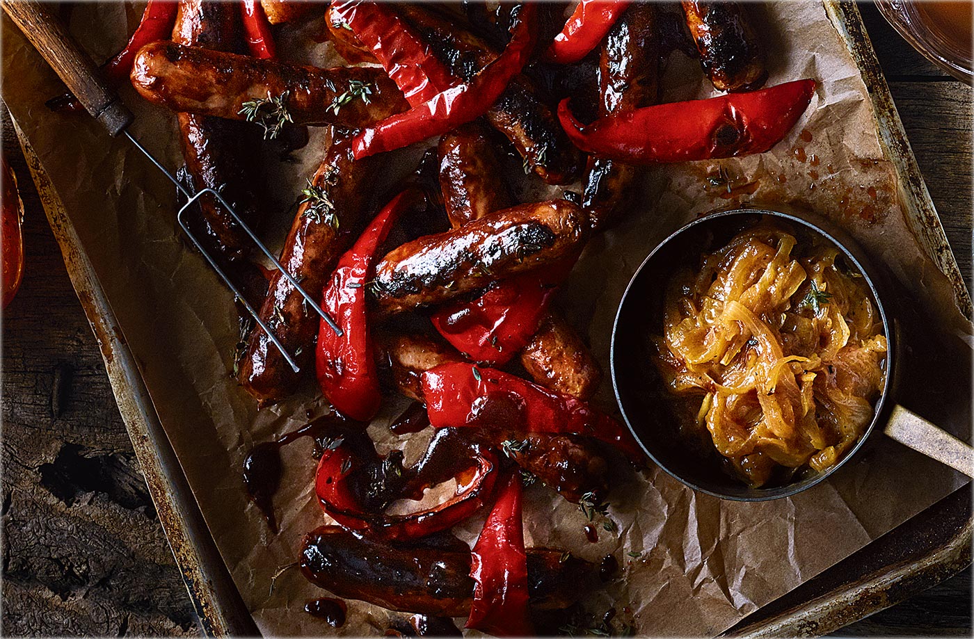Glazed sausages with beer and mustard onions