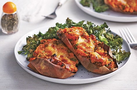 Image of "Loaded sweet potatoes with crispy kale and Cheddar"