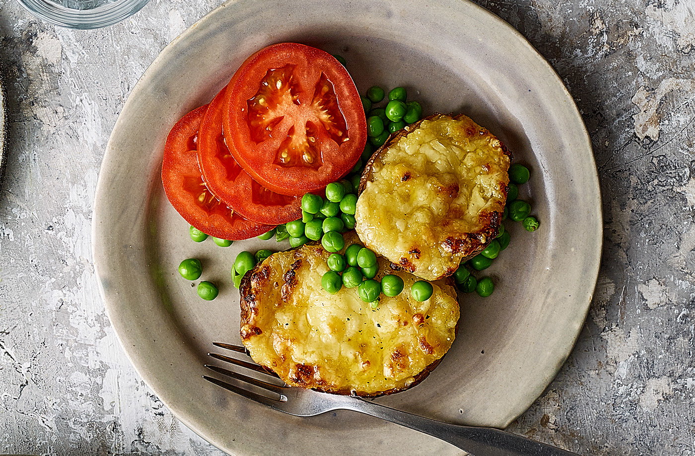Cheesy stuffed potatoes with tomatoes and peas