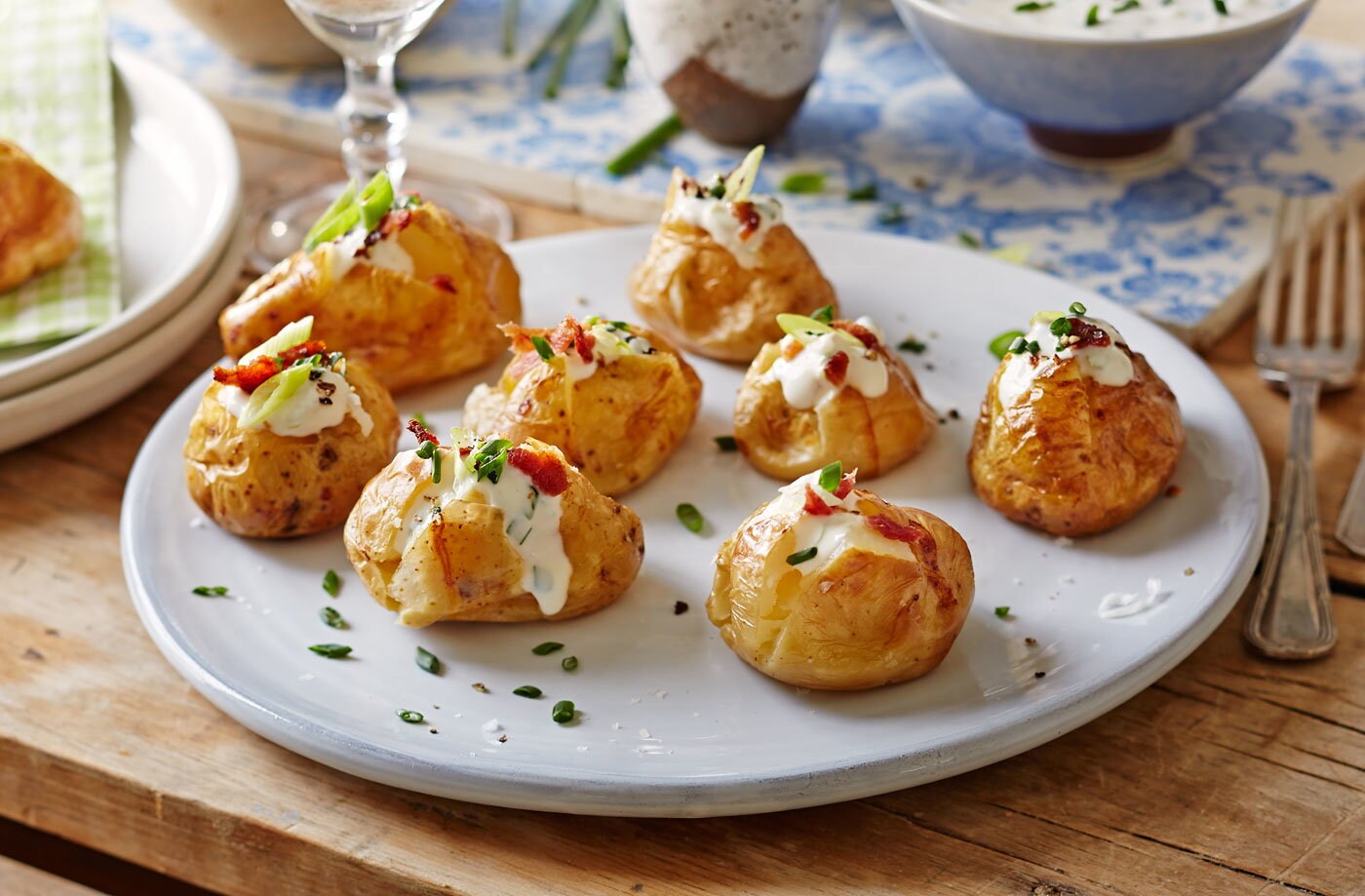 Baked new potatoes with spring onion, sour cream and crispy bacon