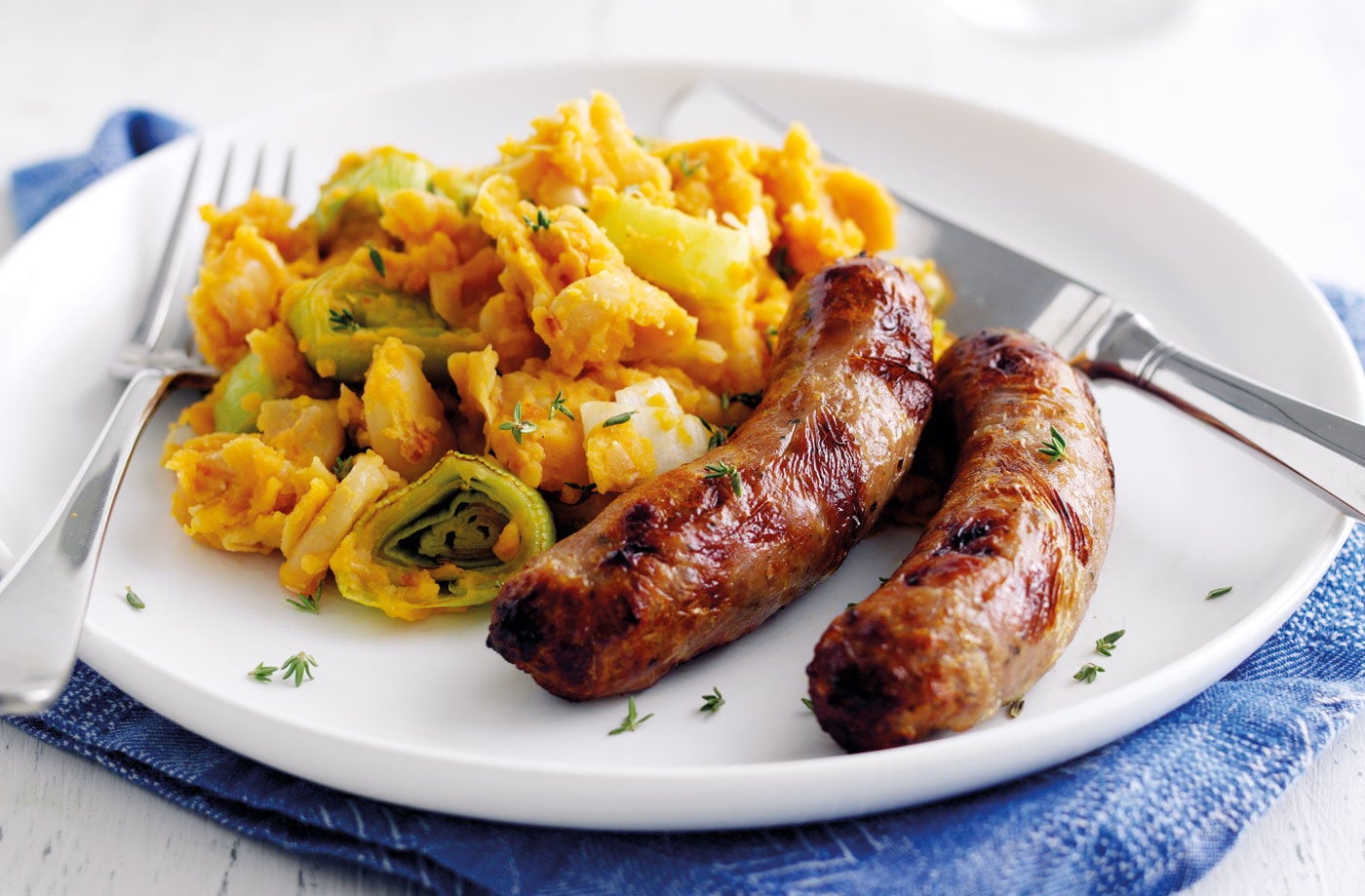 Sausages with tomato, leek and butter bean mash
