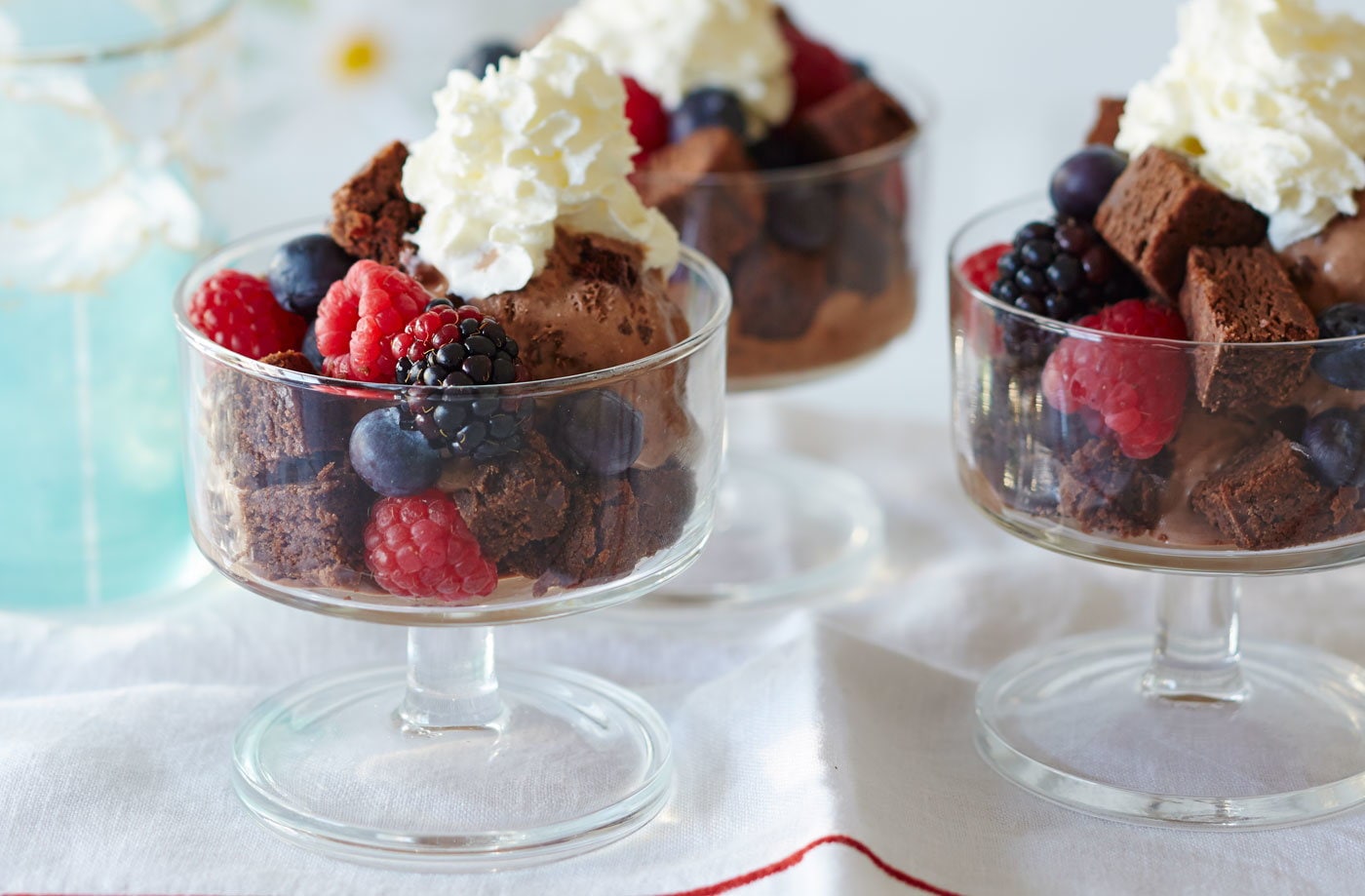Brownie and summer berry sundae with cream