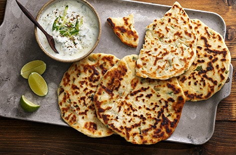 Image of "Garlic and coriander flatbreads with raita"