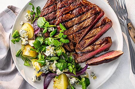 Image of "Ribeye steak with new potatoes, blue cheese and watercress"