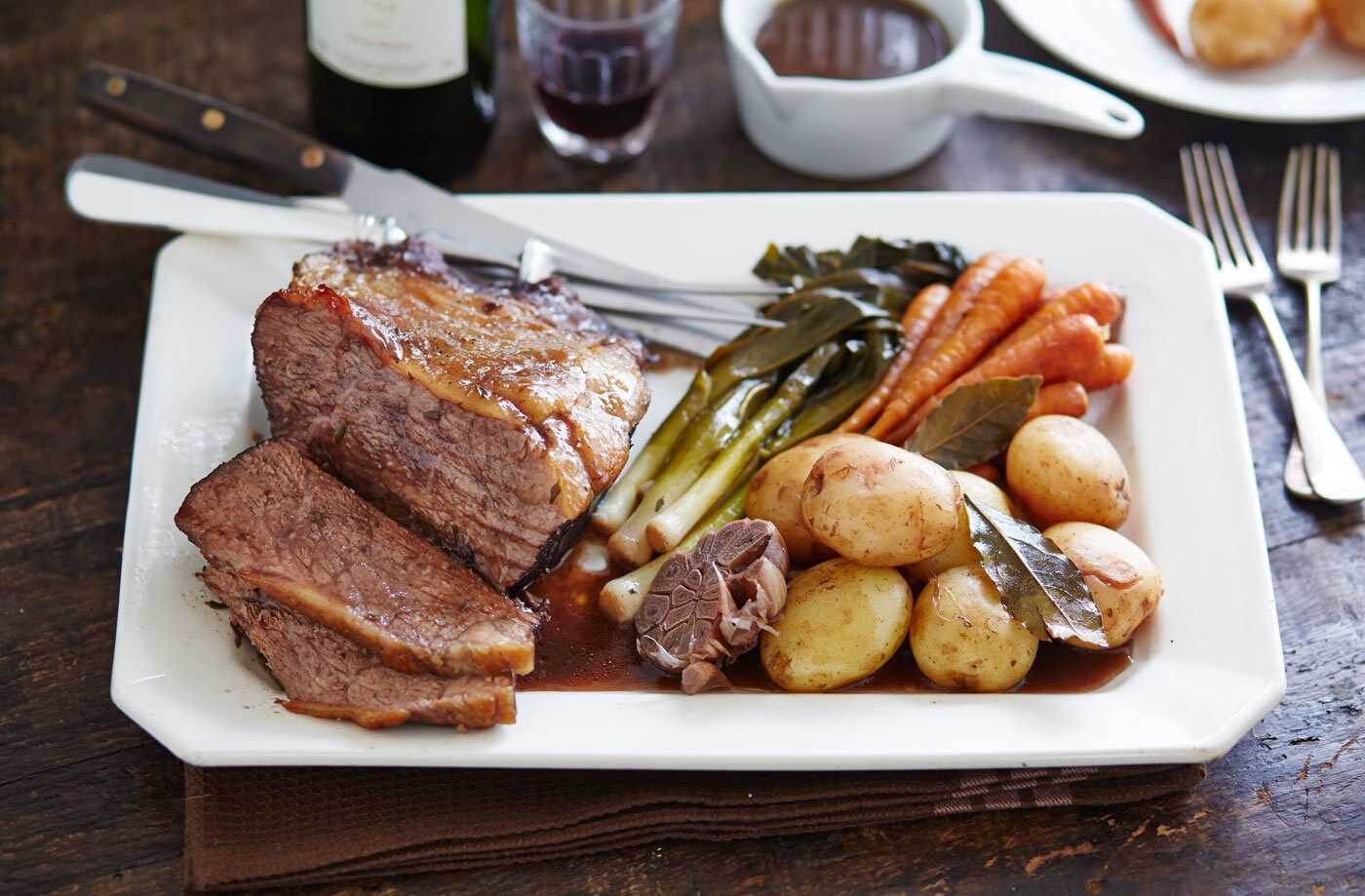 Pot-roasted beef in red wine with baby veg and new potatoes
