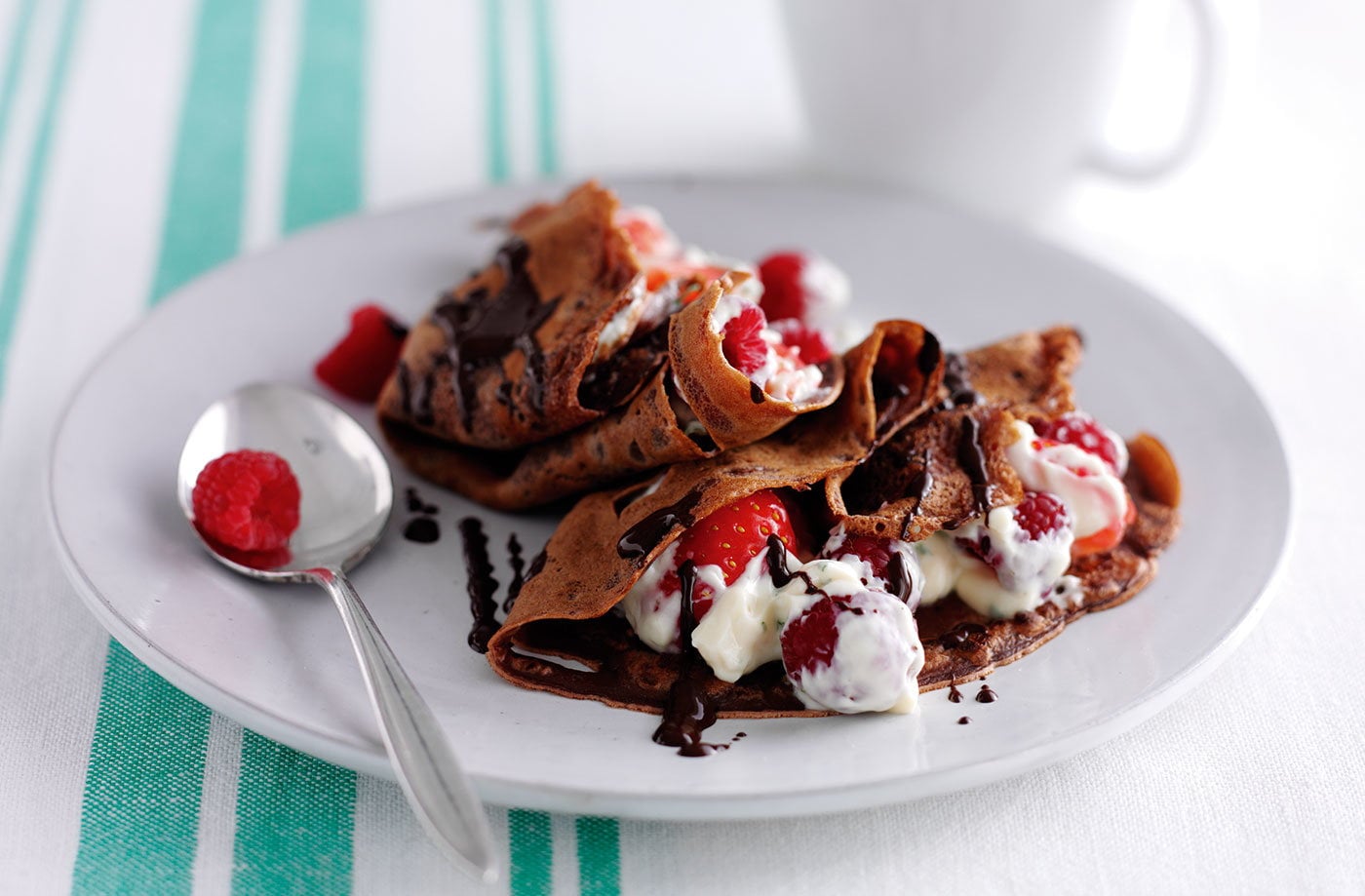 Chocolate pancakes with berries and yogurt