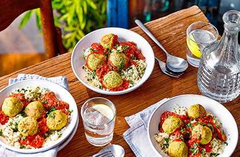 Image of "Tomato falafel traybake with lemony couscous"