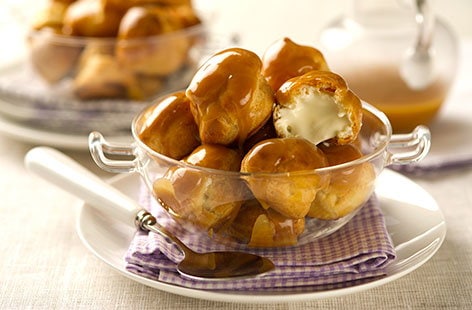 Image of "Profiteroles with cardamom crème fraîche and orange toffee sauce "