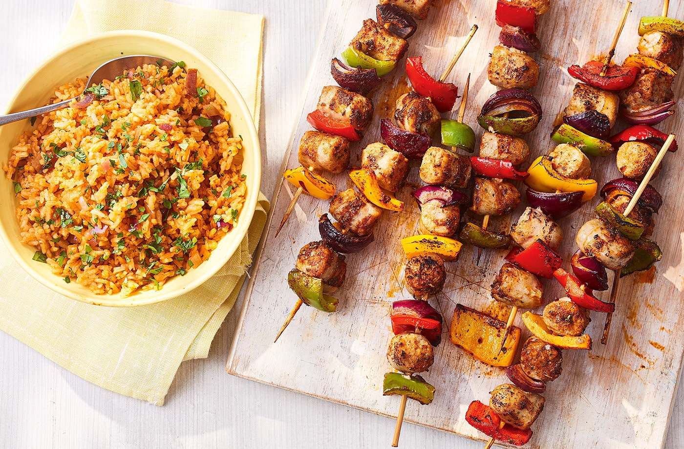 Smoky sausage skewers with tomato rice