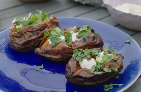 Image of "Ember-roasted sweet potatoes with cream cheese and capers"